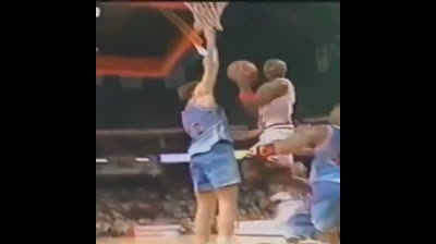 Michael Jordan flying into the basket