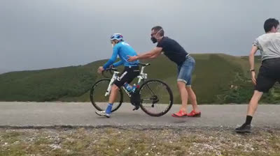 Ayudando a ciclistas a mantenerse en pie frente al fuerte viento en Burgos